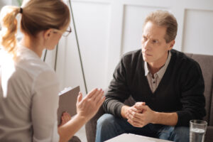 A man listens to the benefits of residential treatment