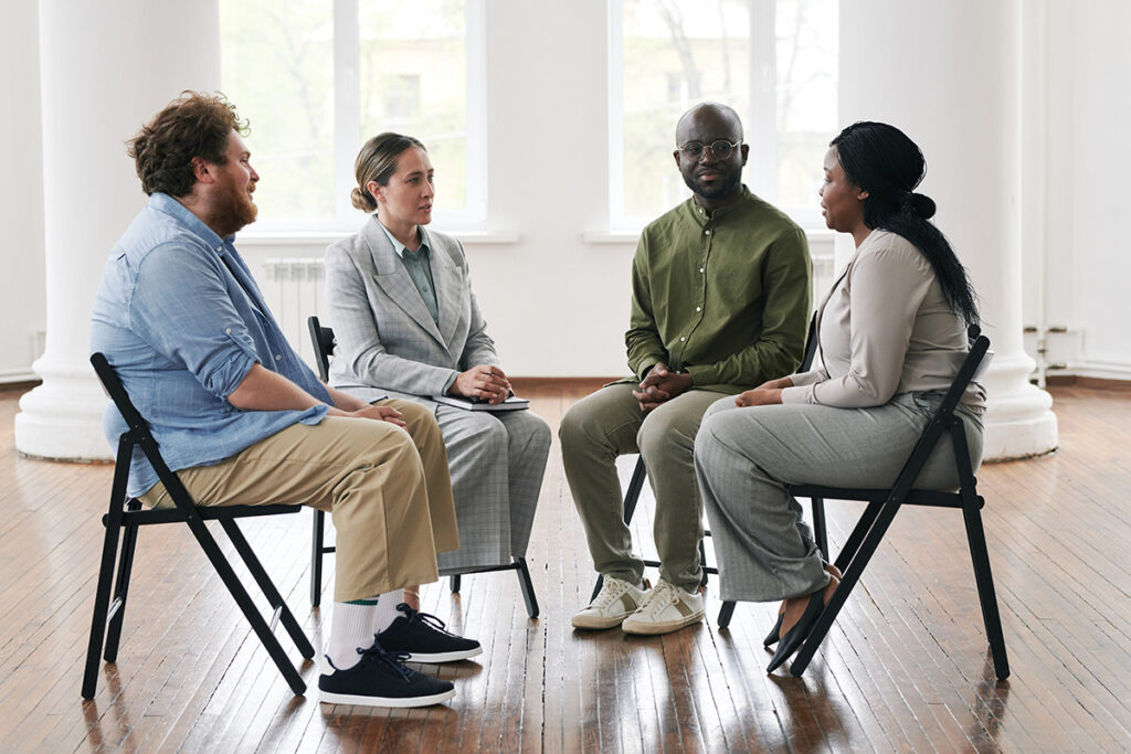 A group of people discuss the benefits of group therapy