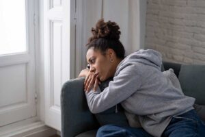 A woman wondering, "Can alcohol overdose cause death?"